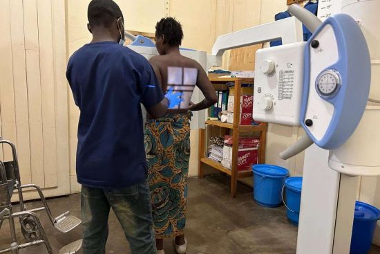 A radiology technician prepares a patient for an X-ray for potential pulmonary tuberculosis (TB) at the general referral hospital of Mweso, North-Kivu. | DR Congo � Laora Vigourt/MSF